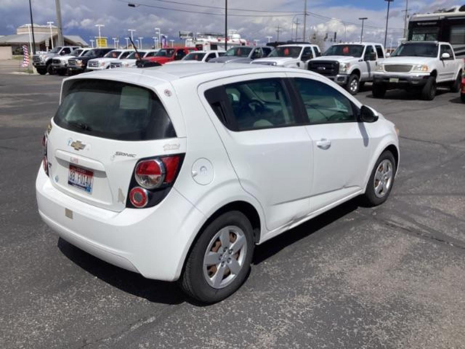 2016 Summit White Chevrolet Sonic LS Auto 5-Door (1G1JA6SH6G4) with an 1.8L L4 DOHC 24V engine, 6-Speed Automatic transmission, located at 1235 N Woodruff Ave., Idaho Falls, 83401, (208) 523-1053, 43.507172, -112.000488 - The 2016 Chevy Sonic LS is a compact car known for its fuel efficiency, nimble handling, and decent amount of standard features. Here's an overview of its key features: Engine Options: The Sonic LS typically comes with a 1.8-liter four-cylinder engine, although some models may have a turbocharged 1 - Photo #4