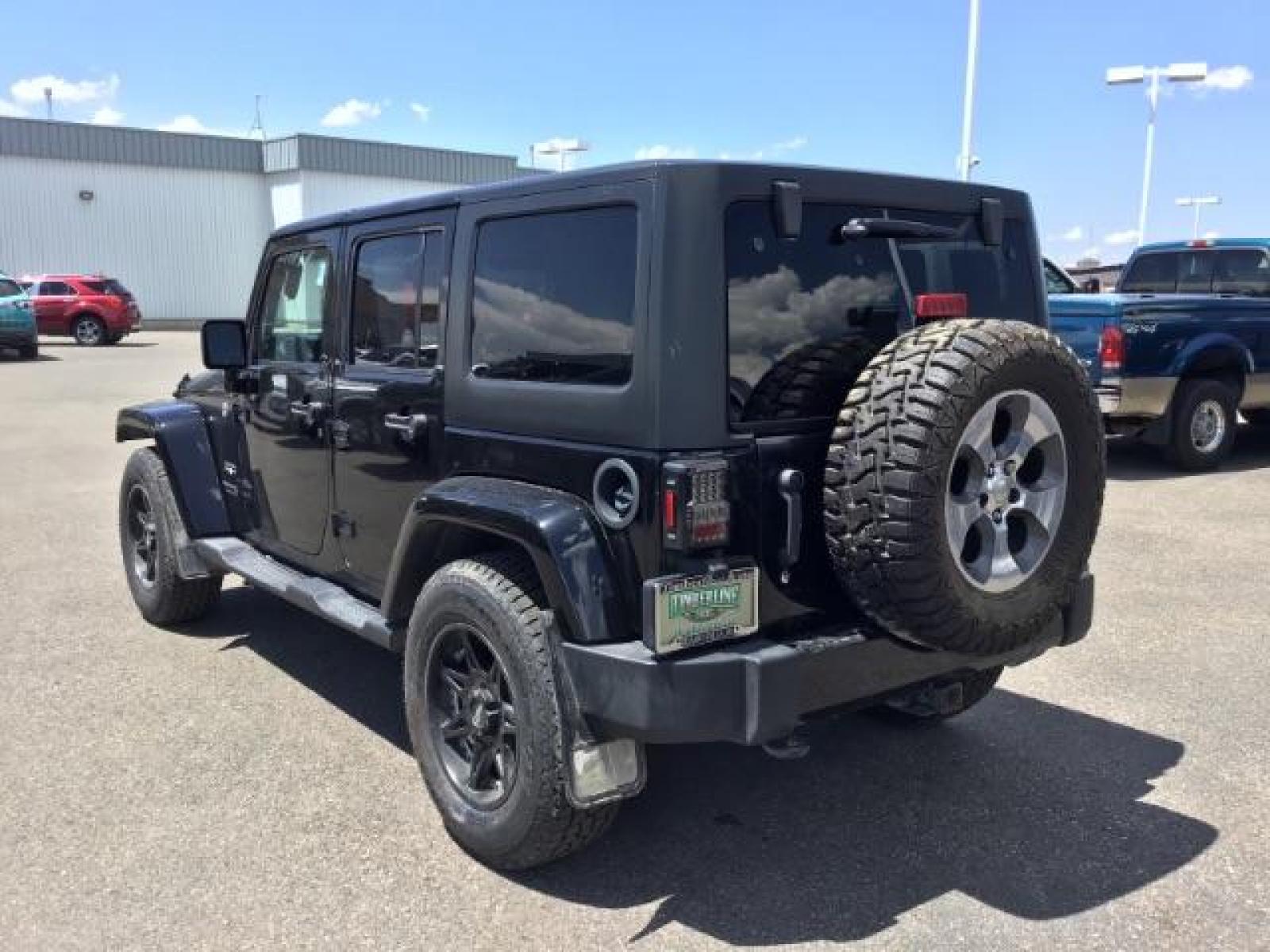 2018 Black Clear Coat /Black, cloth Jeep Wrangler JK Unlimited Sahara 4WD (1C4BJWEG8JL) with an 3.6L V6 DOHC 24V FFV engine, 6-Speed Automatic transmission, located at 1235 N Woodruff Ave., Idaho Falls, 83401, (208) 523-1053, 43.507172, -112.000488 - This Jeep is in very good condition and has a few aftermarket parts like the Angry Jeep Face grill replacement, MOTO METAL wheels, light pods, light bars, aftermarket front bumper, head lights, and tail lights. Inside you'll see the clean Sahara premium seats, a large infotainment screen, the ALPINE - Photo #3