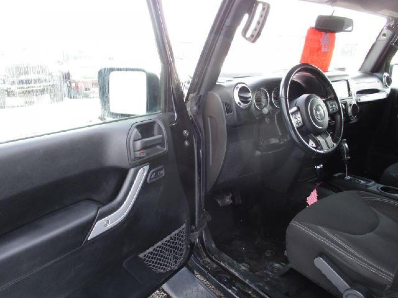 2018 Black Clear Coat /Black, cloth Jeep Wrangler JK Unlimited Sahara 4WD (1C4BJWEG8JL) with an 3.6L V6 DOHC 24V FFV engine, 6-Speed Automatic transmission, located at 1235 N Woodruff Ave., Idaho Falls, 83401, (208) 523-1053, 43.507172, -112.000488 - This Jeep is in very good condition and has a few aftermarket parts like the Angry Jeep Face grill replacement, MOTO METAL wheels, light pods, light bars, aftermarket front bumper, head lights, and tail lights. Inside you'll see the clean Sahara premium seats, a large infotainment screen, the ALPINE - Photo #9