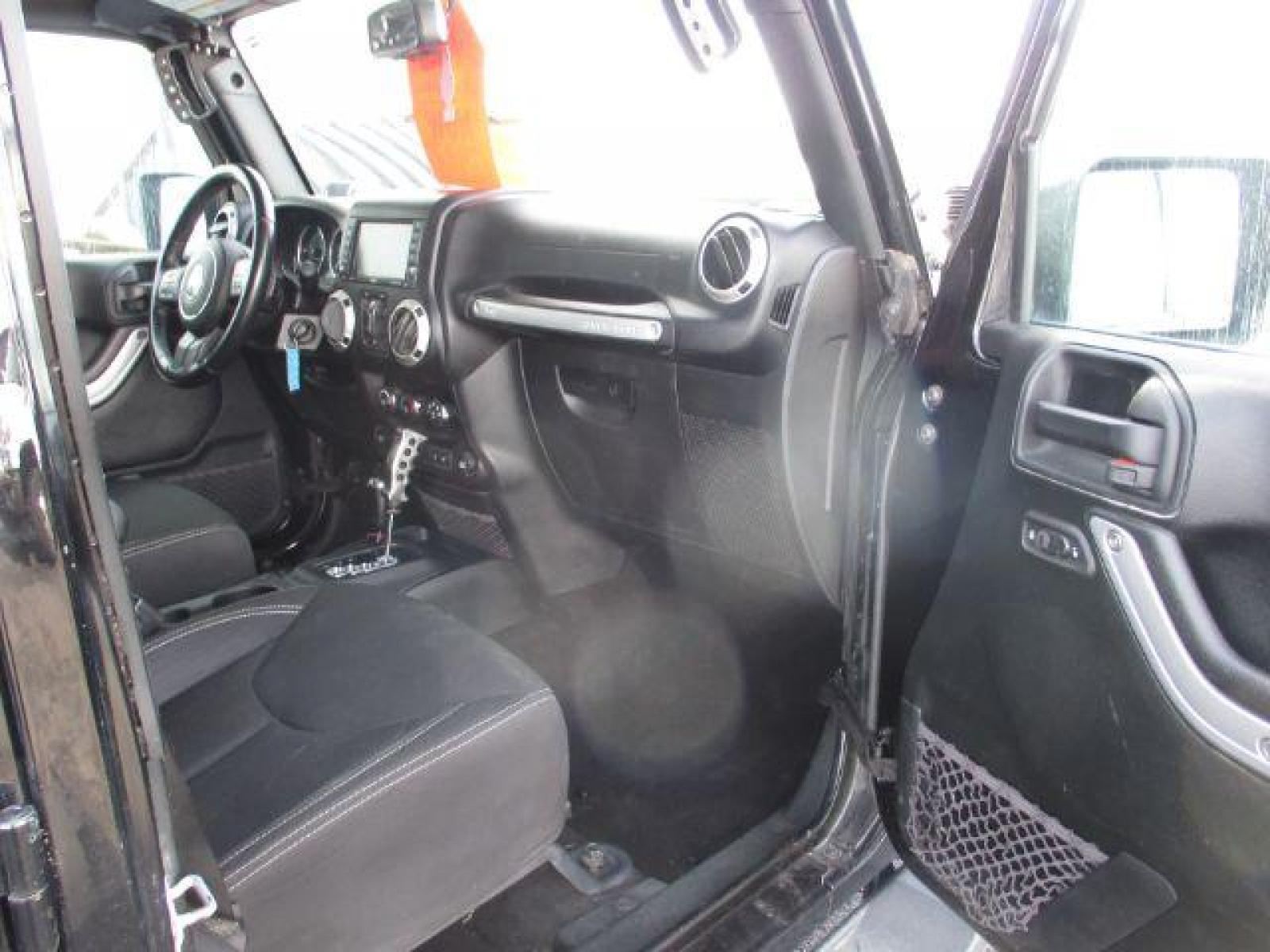 2018 Black Clear Coat /Black, cloth Jeep Wrangler JK Unlimited Sahara 4WD (1C4BJWEG8JL) with an 3.6L V6 DOHC 24V FFV engine, 6-Speed Automatic transmission, located at 1235 N Woodruff Ave., Idaho Falls, 83401, (208) 523-1053, 43.507172, -112.000488 - This Jeep is in very good condition and has a few aftermarket parts like the Angry Jeep Face grill replacement, MOTO METAL wheels, light pods, light bars, aftermarket front bumper, head lights, and tail lights. Inside you'll see the clean Sahara premium seats, a large infotainment screen, the ALPINE - Photo #17