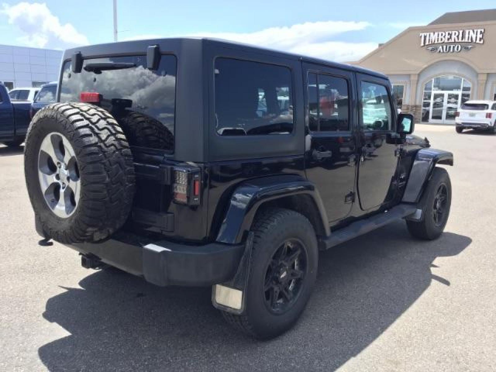 2018 Black Clear Coat /Black, cloth Jeep Wrangler JK Unlimited Sahara 4WD (1C4BJWEG8JL) with an 3.6L V6 DOHC 24V FFV engine, 6-Speed Automatic transmission, located at 1235 N Woodruff Ave., Idaho Falls, 83401, (208) 523-1053, 43.507172, -112.000488 - This Jeep is in very good condition and has a few aftermarket parts like the Angry Jeep Face grill replacement, MOTO METAL wheels, light pods, light bars, aftermarket front bumper, head lights, and tail lights. Inside you'll see the clean Sahara premium seats, a large infotainment screen, the ALPINE - Photo #5
