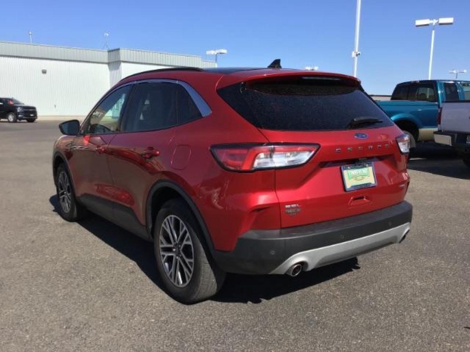 2021 Rapid Red Metallic Tinted Clearcoat /Ebony Ford Escape SEL AWD (1FMCU9H62MU) with an 1.5L L3 engine, 8-Speed Automatic transmission, located at 1235 N Woodruff Ave., Idaho Falls, 83401, (208) 523-1053, 43.507172, -112.000488 - 2021 Ford Escape SEL package with the 1.5L EcoBoost engine, heated seats, remote start, dual moonroof, and so much more! At Timberline Auto it is always easy to find a great deal on your next vehicle! Our experienced sales staff can help find the right vehicle that will fit your needs. Our knowled - Photo #3