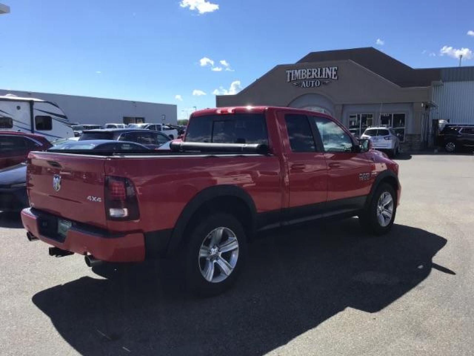 2013 Flame Red /Black Cloth Interior RAM 1500 Sport Quad Cab 4WD (1C6RR7HT4DS) with an 5.7L V8 OHV 16V engine, 6-Speed Automatic transmission, located at 1235 N Woodruff Ave., Idaho Falls, 83401, (208) 523-1053, 43.507172, -112.000488 - Leather, sport package, 4X4, Bluetooth, Alpine Sound System, heated and cooled seats, heated steering wheel, tow package, 6.6' bed, Tonneau cover. At Timberline Auto it is always easy to find a great deal on your next vehicle! Our experienced sales staff can help find the right vehicle that will fi - Photo #4