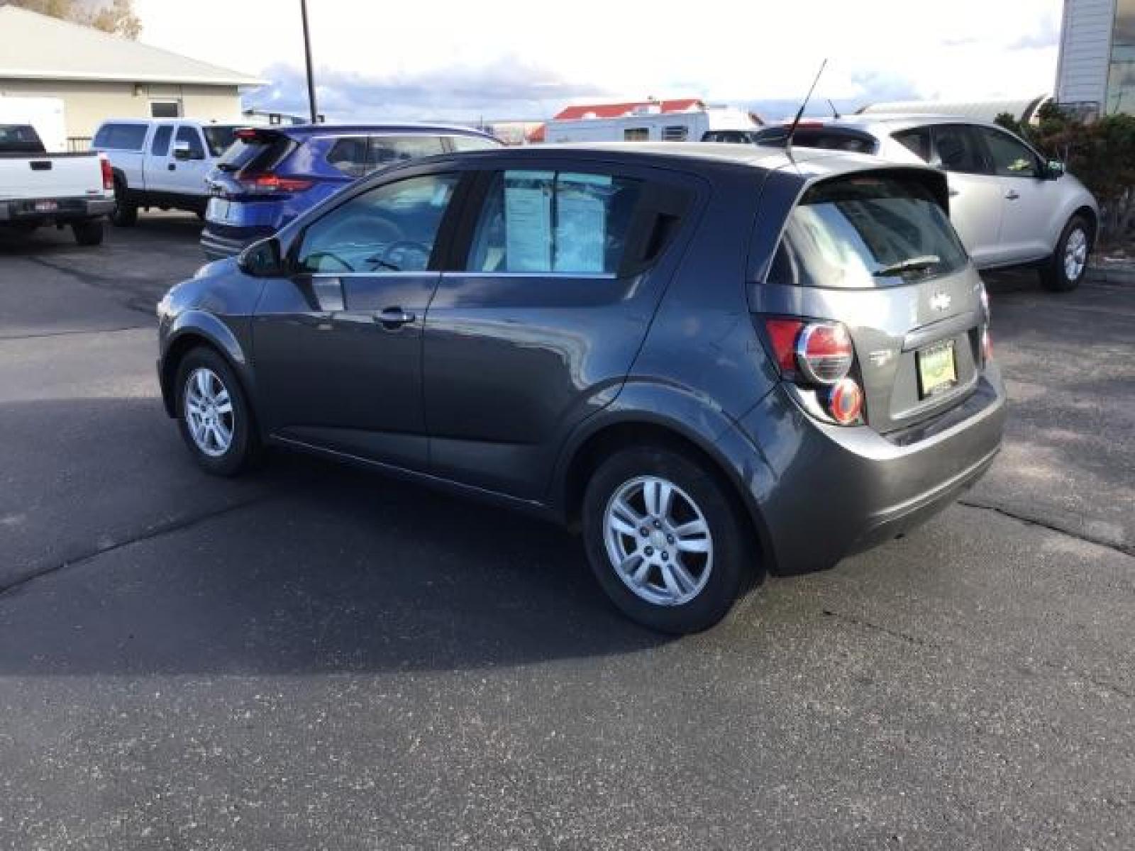 2013 Black Granite Metallic Chevrolet Sonic LT Auto 5-Door (1G1JC6SG7D4) with an 1.8L L4 DOHC 24V engine, 6-Speed Automatic transmission, located at 1235 N Woodruff Ave., Idaho Falls, 83401, (208) 523-1053, 43.507172, -112.000488 - This 2013 Chevrolet Sonic, has the 4 cylinder motor. It has 95,000 miles. It comes with Steering wheel audio controls, cruise control, bluetooth audio, and CD player. At Timberline Auto it is always easy to find a great deal on your next vehicle! Our experienced sales staff can help find the right v - Photo #2