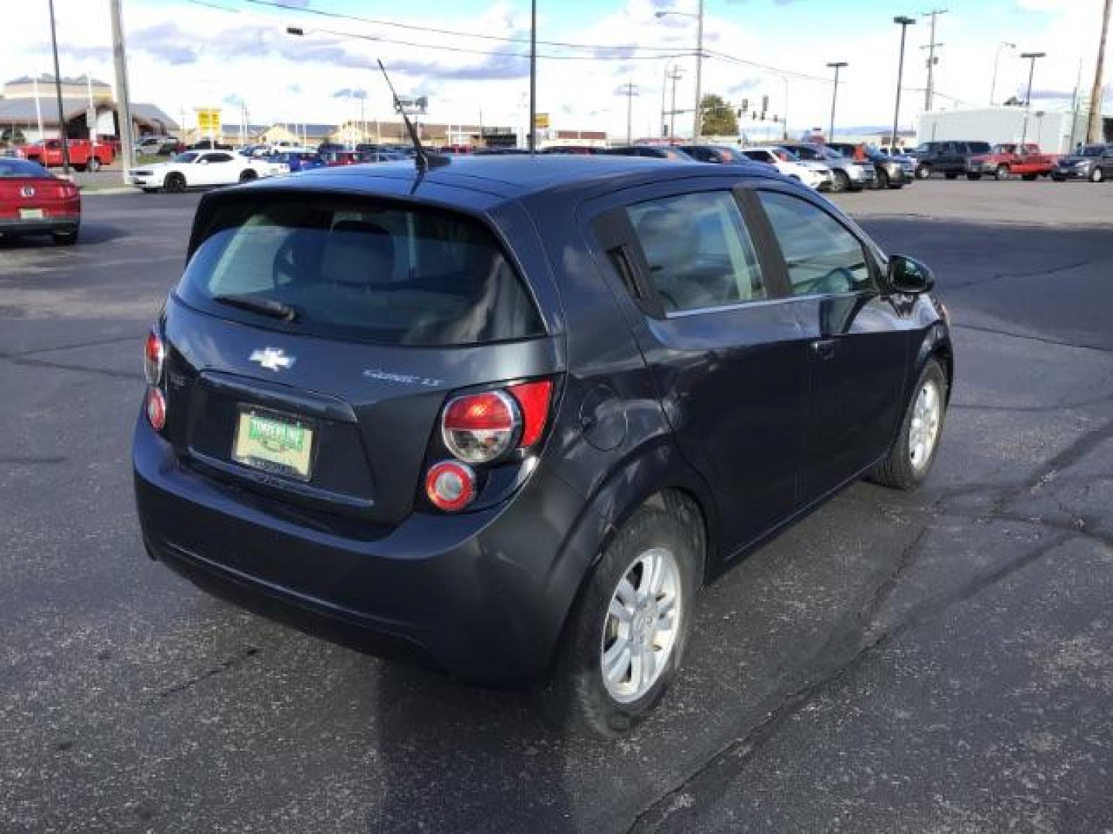 2013 Black Granite Metallic Chevrolet Sonic LT Auto 5-Door (1G1JC6SG7D4) with an 1.8L L4 DOHC 24V engine, 6-Speed Automatic transmission, located at 1235 N Woodruff Ave., Idaho Falls, 83401, (208) 523-1053, 43.507172, -112.000488 - This 2013 Chevrolet Sonic, has the 4 cylinder motor. It has 95,000 miles. It comes with Steering wheel audio controls, cruise control, bluetooth audio, and CD player. At Timberline Auto it is always easy to find a great deal on your next vehicle! Our experienced sales staff can help find the right v - Photo #4