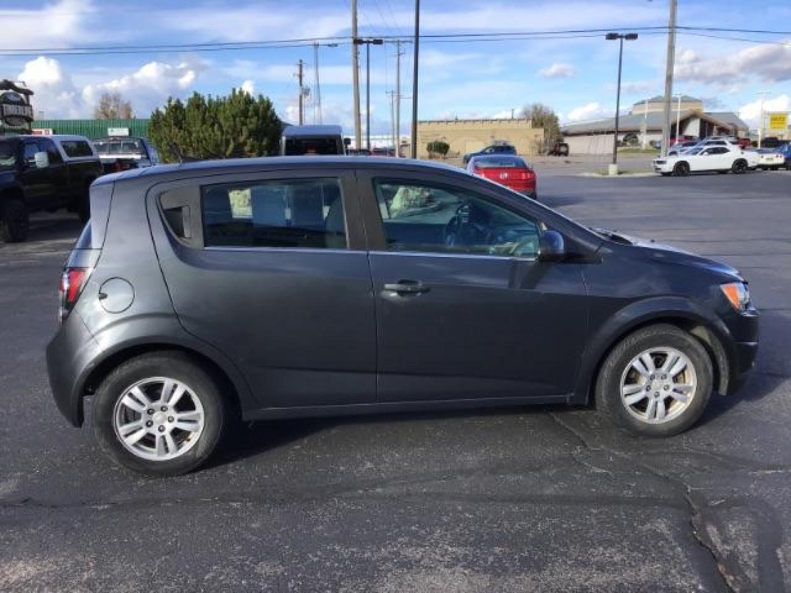 2013 Black Granite Metallic Chevrolet Sonic LT Auto 5-Door (1G1JC6SG7D4) with an 1.8L L4 DOHC 24V engine, 6-Speed Automatic transmission, located at 1235 N Woodruff Ave., Idaho Falls, 83401, (208) 523-1053, 43.507172, -112.000488 - This 2013 Chevrolet Sonic, has the 4 cylinder motor. It has 95,000 miles. It comes with Steering wheel audio controls, cruise control, bluetooth audio, and CD player. At Timberline Auto it is always easy to find a great deal on your next vehicle! Our experienced sales staff can help find the right v - Photo #5