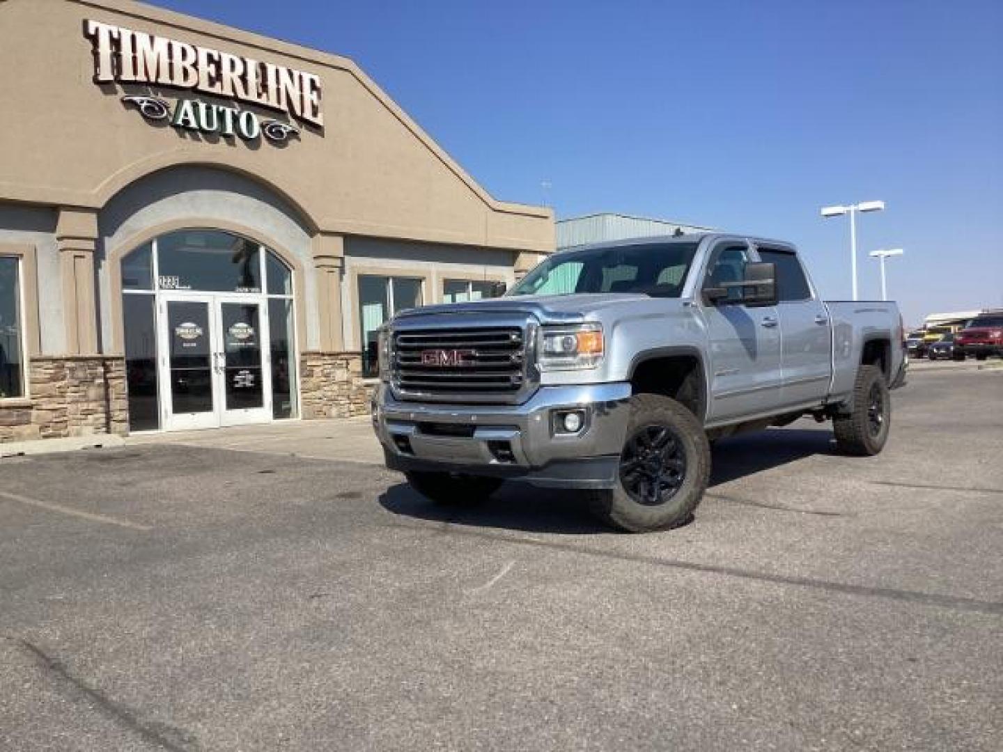 2015 Quicksilver Metallic /Jet Black GMC Sierra 2500HD SLT Crew Cab 4WD (1GT12ZE88FF) with an 6.6L V8 OHV 16V DIESEL engine, 6-Speed Automatic transmission, located at 1235 N Woodruff Ave., Idaho Falls, 83401, (208) 523-1053, 43.507172, -112.000488 - Photo#0