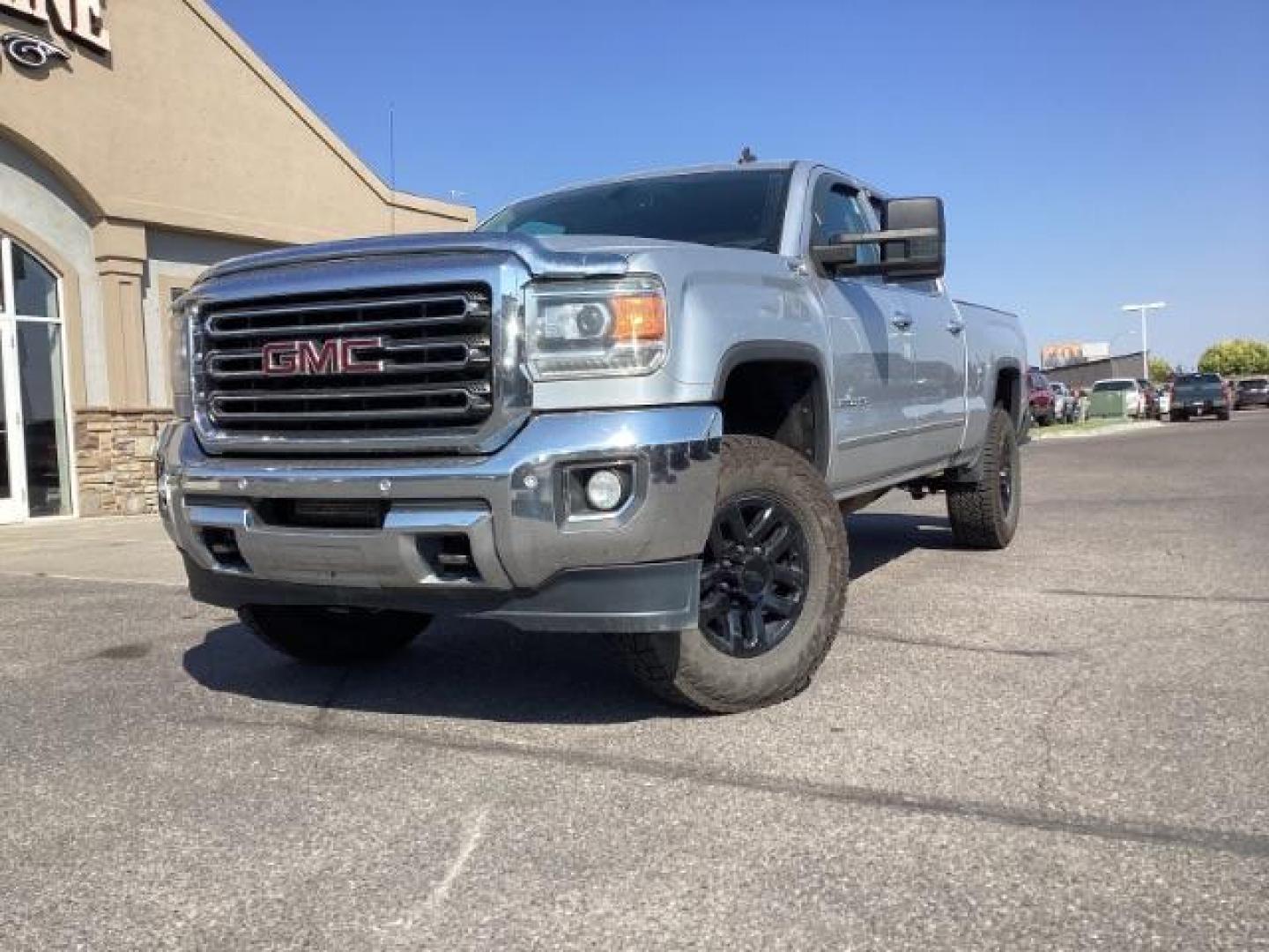 2015 Quicksilver Metallic /Jet Black GMC Sierra 2500HD SLT Crew Cab 4WD (1GT12ZE88FF) with an 6.6L V8 OHV 16V DIESEL engine, 6-Speed Automatic transmission, located at 1235 N Woodruff Ave., Idaho Falls, 83401, (208) 523-1053, 43.507172, -112.000488 - Photo#1