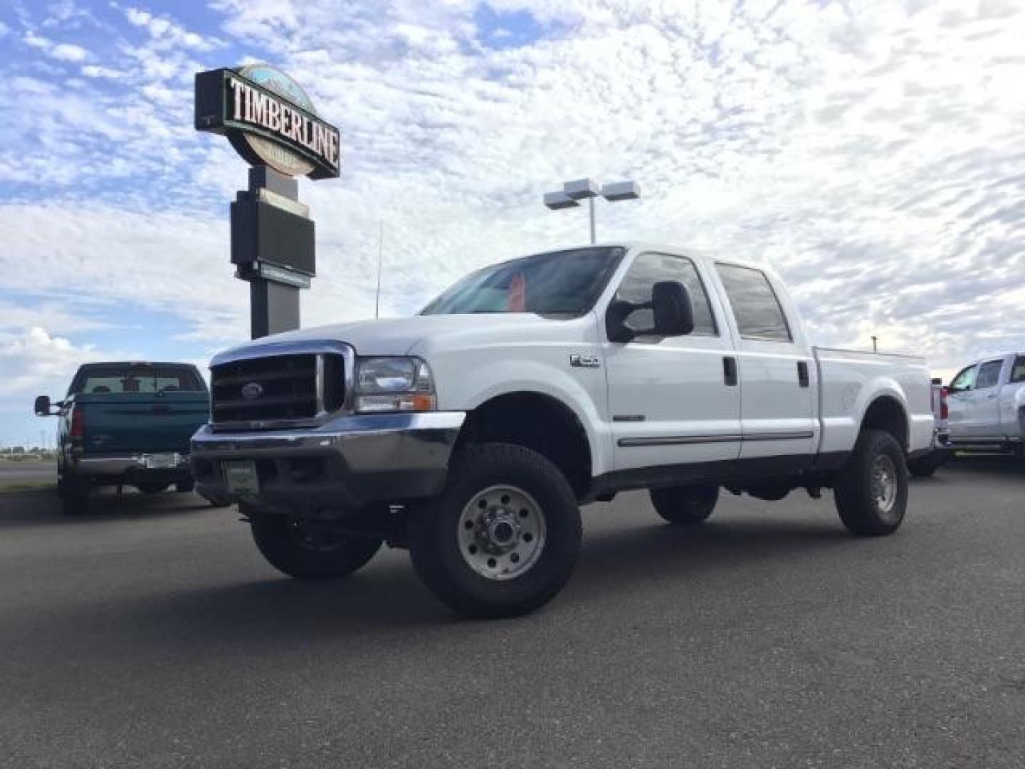 1999 Oxford White Clearcoat /Medium Graphite Cloth Ford F-250 SD XLT Crew Cab SWB 4WD (1FTNW21F4XE) with an 7.3L V8 OHV 16V TURBO DIESEL engine, 4-Speed Automatic transmission, located at 1235 N Woodruff Ave., Idaho Falls, 83401, (208) 523-1053, 43.507172, -112.000488 - This F-250 7.3L Powertstroke runs and drives very well! The body and paint are in good shape and the interior is in great condition! The tires are near new with 90% plus tread left. Your new pre-owned Ford diesel has a spray in bed liner, aftermarket trailer brake installed, 'A' pillar gauge pods, a - Photo#0