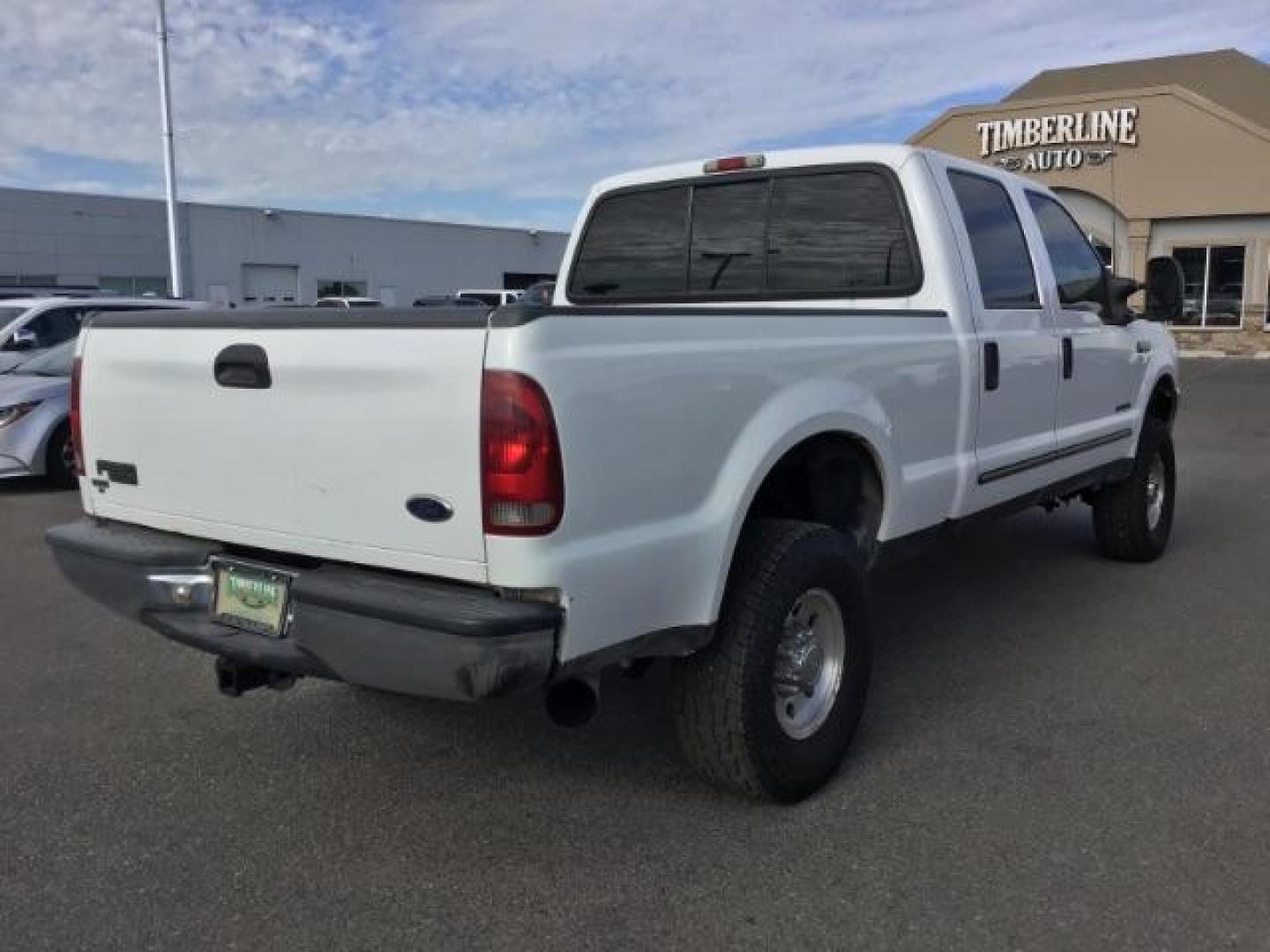 1999 Oxford White Clearcoat /Medium Graphite Cloth Ford F-250 SD XLT Crew Cab SWB 4WD (1FTNW21F4XE) with an 7.3L V8 OHV 16V TURBO DIESEL engine, 4-Speed Automatic transmission, located at 1235 N Woodruff Ave., Idaho Falls, 83401, (208) 523-1053, 43.507172, -112.000488 - This F-250 7.3L Powertstroke runs and drives very well! The body and paint are in good shape and the interior is in great condition! The tires are near new with 90% plus tread left. Your new pre-owned Ford diesel has a spray in bed liner, aftermarket trailer brake installed, 'A' pillar gauge pods, a - Photo#5