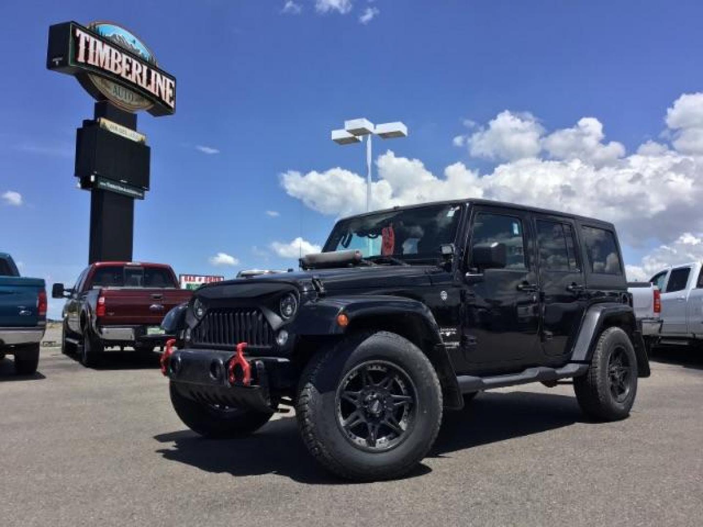 2018 Black Clear Coat /Black, cloth Jeep Wrangler JK Unlimited Sahara 4WD (1C4BJWEG8JL) with an 3.6L V6 DOHC 24V FFV engine, 6-Speed Automatic transmission, located at 1235 N Woodruff Ave., Idaho Falls, 83401, (208) 523-1053, 43.507172, -112.000488 - This Jeep is in very good condition and has a few aftermarket parts like the Angry Jeep Face grill replacement, MOTO METAL wheels, light pods, light bars, aftermarket front bumper, head lights, and tail lights. Inside you'll see the clean Sahara premium seats, a large infotainment screen, the ALPINE - Photo#0