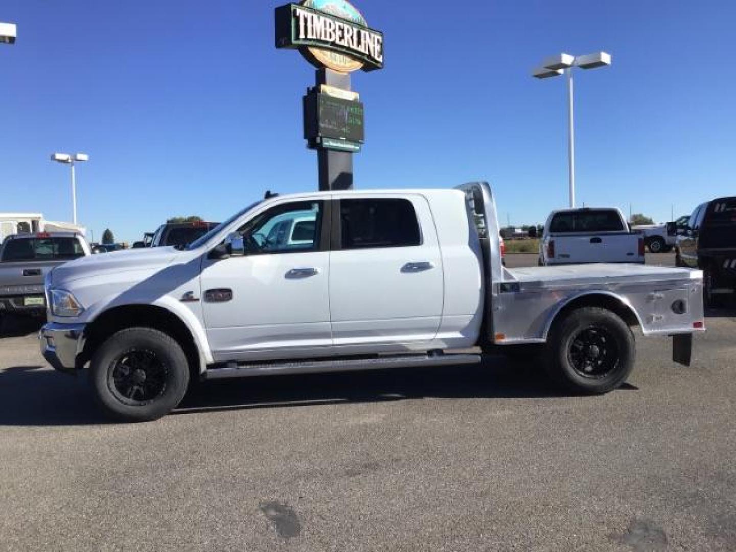 2015 Bright White Clear Coat /LEATHER RAM 2500 Longhorn Mega Cab SWB 4WD (3C6UR5PL9FG) with an 6.7L L6 OHV 24V TURBO DIESEL engine, 6-Speed Automatic transmission, located at 1235 N Woodruff Ave., Idaho Falls, 83401, (208) 523-1053, 43.507172, -112.000488 - This 2015 Ram 2500 Mega Cab Longhorn Edition, has the 6.7L Diesel motor. It has 159,423 miles. It comes with a flat bed, running boards, sunroof, heated and cooled seats, and rear heated seats. At Timberline Auto it is always easy to find a great deal on your next vehicle! Our experienced sales st - Photo#1