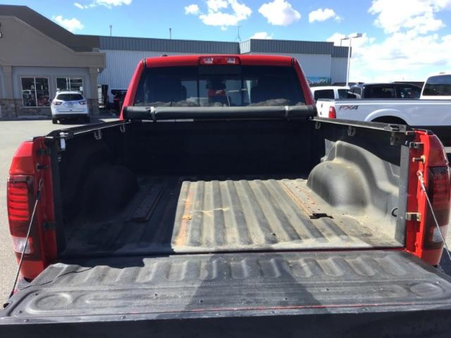 2013 Flame Red /Black Cloth Interior RAM 1500 Sport Quad Cab 4WD (1C6RR7HT4DS) with an 5.7L V8 OHV 16V engine, 6-Speed Automatic transmission, located at 1235 N Woodruff Ave., Idaho Falls, 83401, (208) 523-1053, 43.507172, -112.000488 - Leather, sport package, 4X4, Bluetooth, Alpine Sound System, heated and cooled seats, heated steering wheel, tow package, 6.6' bed, Tonneau cover. At Timberline Auto it is always easy to find a great deal on your next vehicle! Our experienced sales staff can help find the right vehicle that will fi - Photo#7