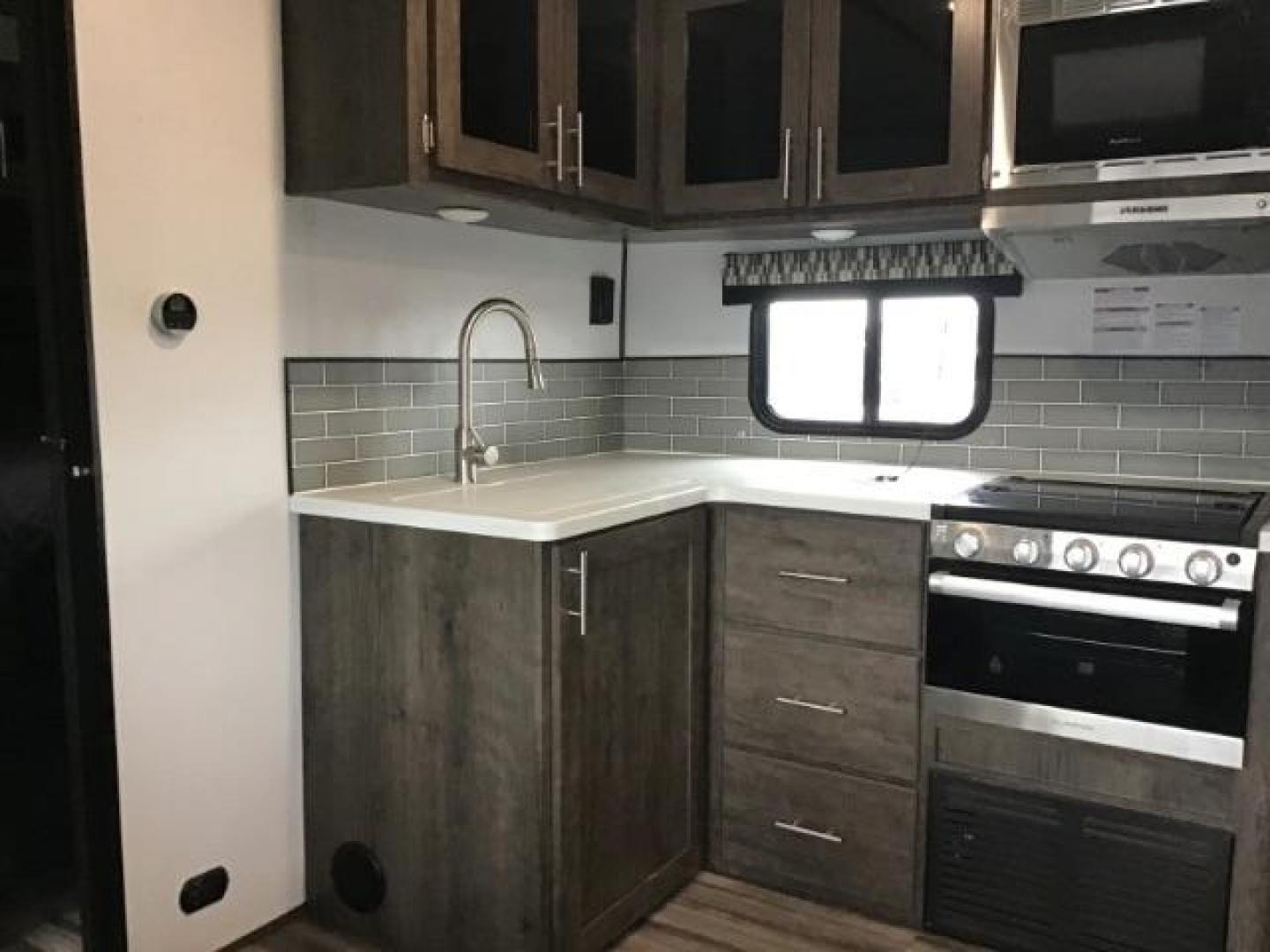 2021 WHITE Riverside RV INTREPID RB200 (59CCC2920ML) , located at 1235 N Woodruff Ave., Idaho Falls, 83401, (208) 523-1053, 43.507172, -112.000488 - 4 leveling jacks, stabilizer with heavy duty adjustable drop hitch, outdoor speakers and lights, power awning and slides, 500# rear cargo rack, new tires, campground cable tv hookup, multiple USB charging ports, easy access fire extinguisher, dual recliners with cup holders, Inno flame fireplace, ga - Photo#12