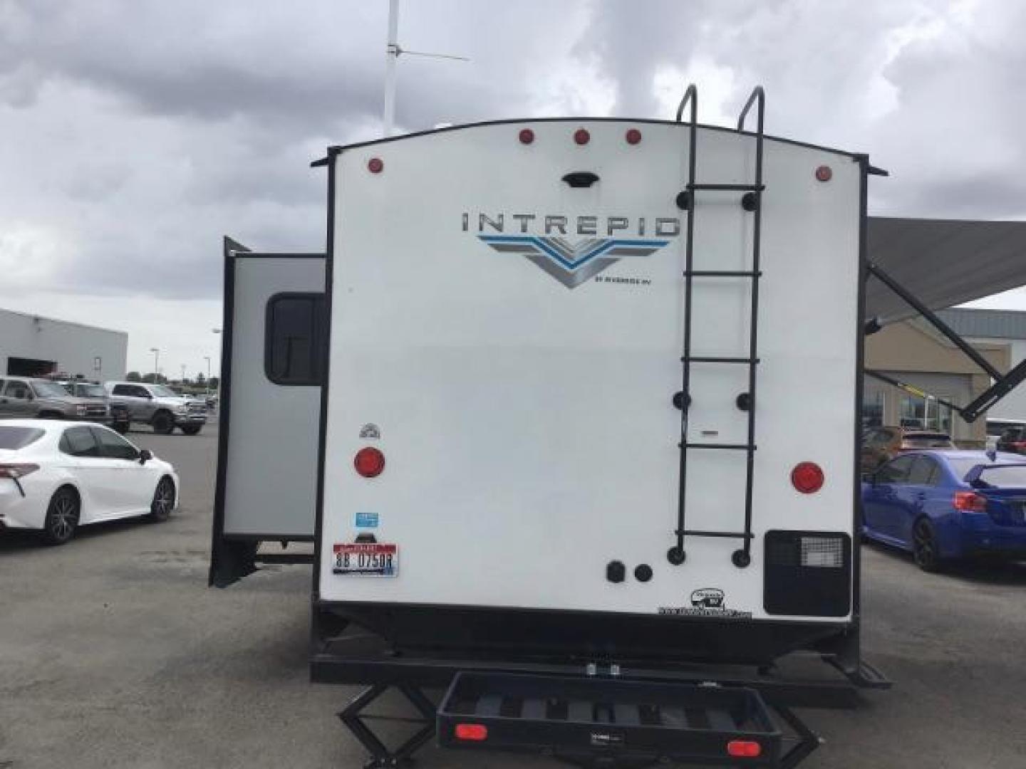 2021 WHITE Riverside RV INTREPID RB200 (59CCC2920ML) , located at 1235 N Woodruff Ave., Idaho Falls, 83401, (208) 523-1053, 43.507172, -112.000488 - 4 leveling jacks, stabilizer with heavy duty adjustable drop hitch, outdoor speakers and lights, power awning and slides, 500# rear cargo rack, new tires, campground cable tv hookup, multiple USB charging ports, easy access fire extinguisher, dual recliners with cup holders, Inno flame fireplace, ga - Photo#2