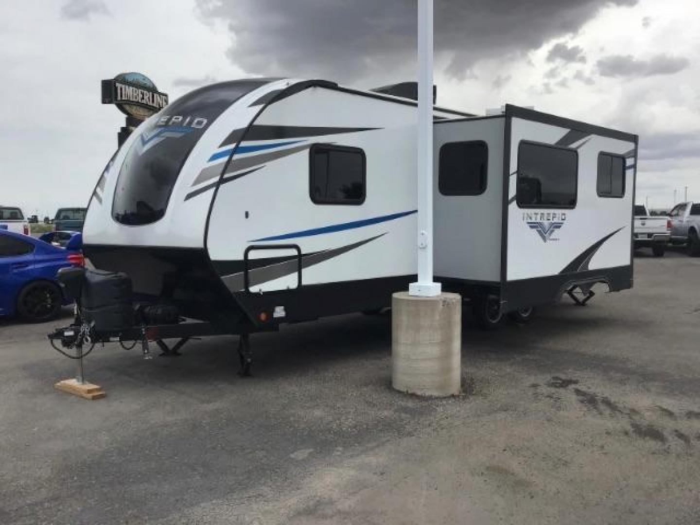 2021 WHITE Riverside RV INTREPID RB200 (59CCC2920ML) , located at 1235 N Woodruff Ave., Idaho Falls, 83401, (208) 523-1053, 43.507172, -112.000488 - 4 leveling jacks, stabilizer with heavy duty adjustable drop hitch, outdoor speakers and lights, power awning and slides, 500# rear cargo rack, new tires, campground cable tv hookup, multiple USB charging ports, easy access fire extinguisher, dual recliners with cup holders, Inno flame fireplace, ga - Photo#4