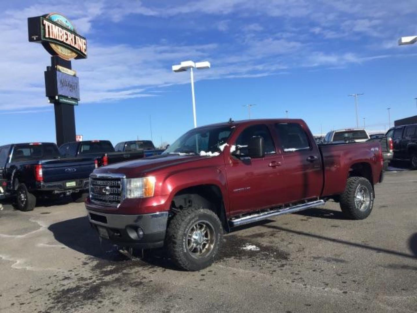 2013 Sonoma Red Metallic /Dark Titanium/Light Titanium Leather Interior GMC Sierra 2500HD SLT Crew Cab 4WD (1GT121C81DF) with an 6.6L V8 OHV 32V TURBO DIESEL engine, 6-Speed Automatic transmission, located at 1235 N Woodruff Ave., Idaho Falls, 83401, (208) 523-1053, 43.507172, -112.000488 - This 2013 GMC Sierra SLT 4x4, has the 6.6L duramax motor. It has 124,000 miles. Comes with leather interior, heated seats, blue tooth, dual power seats, key less remote, and turn over ball. At Timberline Auto it is always easy to find a great deal on your next vehicle! Our experienced sales staff ca - Photo#0