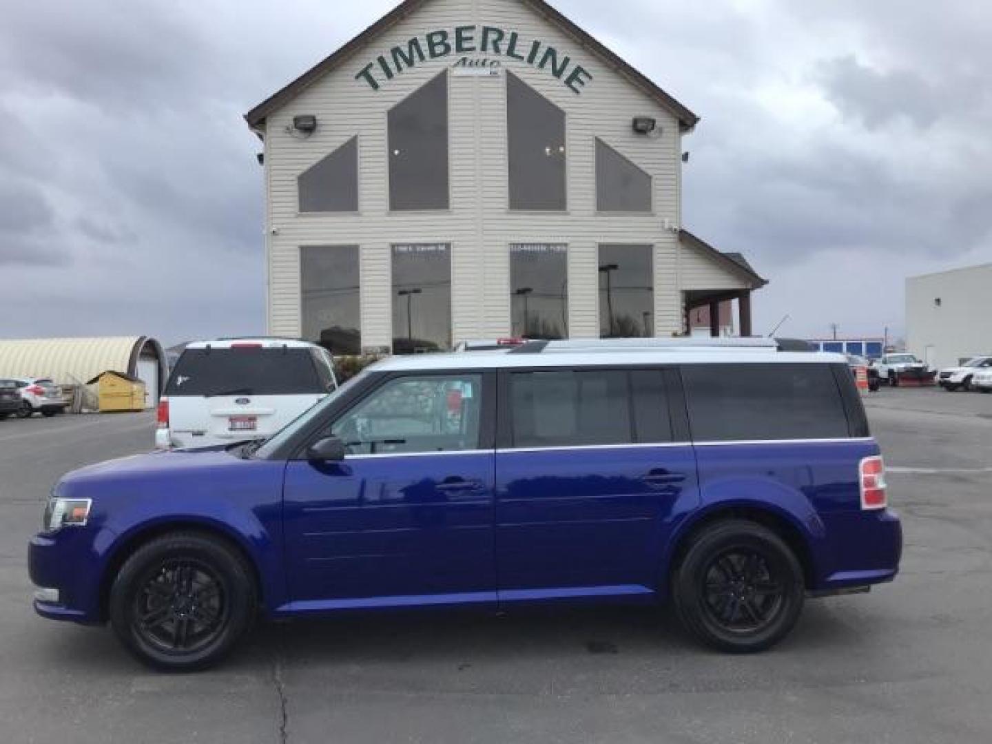 2013 Deep Impact Blue Metallic /Charcoal Black Leather Interior Ford Flex SEL FWD (2FMGK5C88DB) with an 3.5L V6 DOHC 24V engine, 6-Speed Automatic Overdrive transmission, located at 1235 N Woodruff Ave., Idaho Falls, 83401, (208) 523-1053, 43.507172, -112.000488 - This 2013 Ford Flex SEL FWD, has 164,000 miles. Comes with leather interior, heated seats, blue tooth audio, 3rd row seating, power seats, cruise control, and power windows and locks. At Timberline Auto it is always easy to find a great deal on your next vehicle! Our experienced sales staff can help - Photo#1