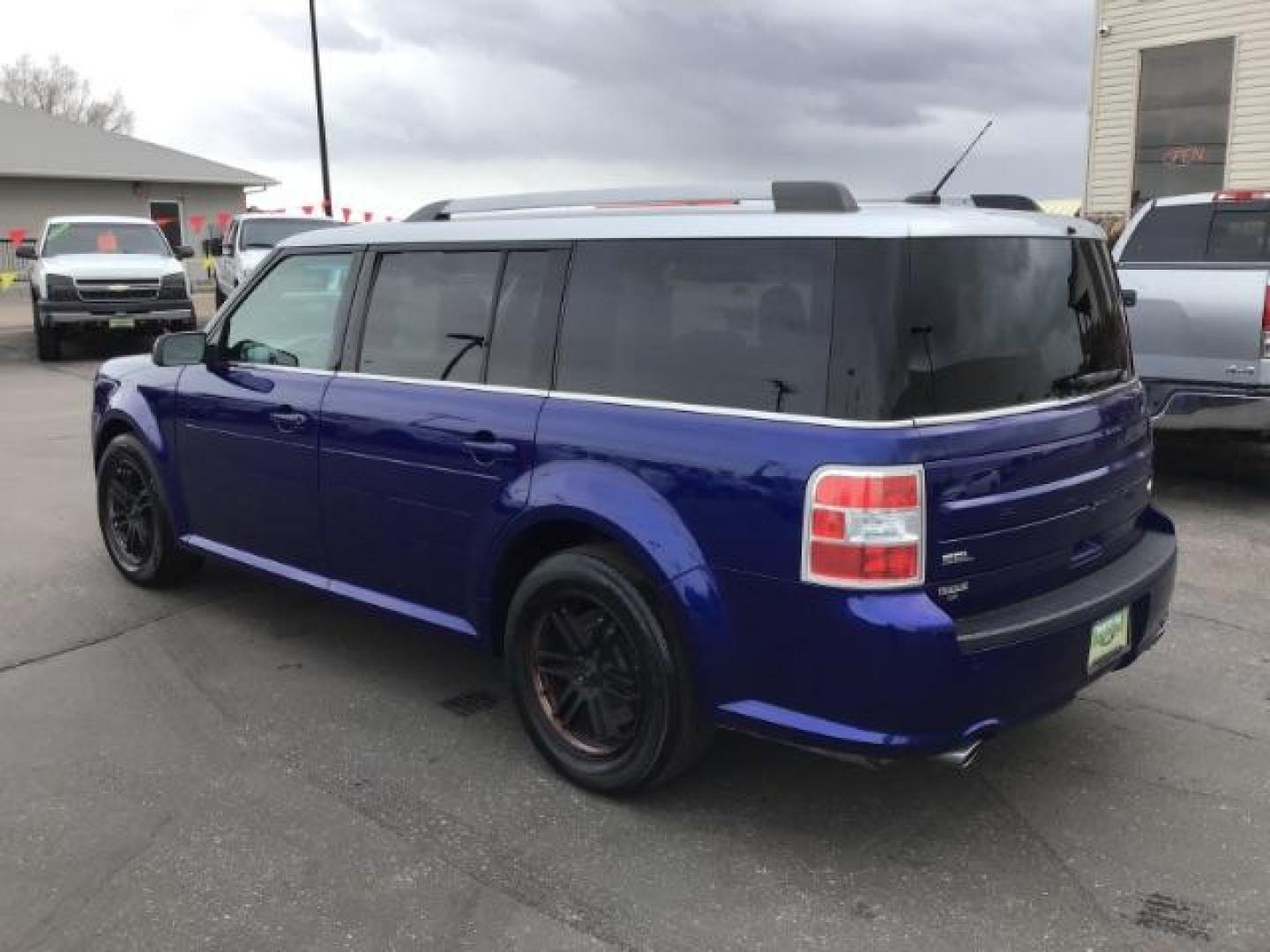 2013 Deep Impact Blue Metallic /Charcoal Black Leather Interior Ford Flex SEL FWD (2FMGK5C88DB) with an 3.5L V6 DOHC 24V engine, 6-Speed Automatic Overdrive transmission, located at 1235 N Woodruff Ave., Idaho Falls, 83401, (208) 523-1053, 43.507172, -112.000488 - This 2013 Ford Flex SEL FWD, has 164,000 miles. Comes with leather interior, heated seats, blue tooth audio, 3rd row seating, power seats, cruise control, and power windows and locks. At Timberline Auto it is always easy to find a great deal on your next vehicle! Our experienced sales staff can help - Photo#2