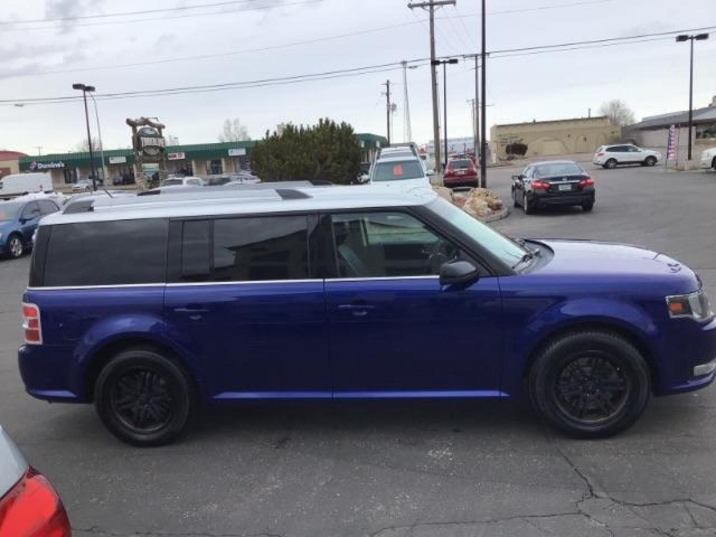 2013 Deep Impact Blue Metallic /Charcoal Black Leather Interior Ford Flex SEL FWD (2FMGK5C88DB) with an 3.5L V6 DOHC 24V engine, 6-Speed Automatic Overdrive transmission, located at 1235 N Woodruff Ave., Idaho Falls, 83401, (208) 523-1053, 43.507172, -112.000488 - This 2013 Ford Flex SEL FWD, has 164,000 miles. Comes with leather interior, heated seats, blue tooth audio, 3rd row seating, power seats, cruise control, and power windows and locks. At Timberline Auto it is always easy to find a great deal on your next vehicle! Our experienced sales staff can help - Photo#5