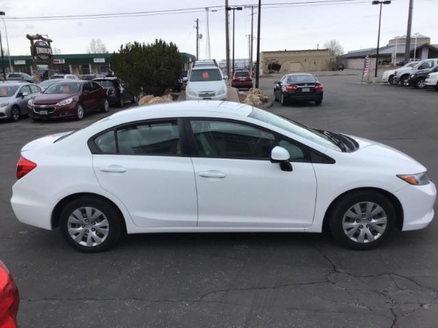 2012 Taffeta White /Gray Cloth Interior Honda Civic LX Sedan 5-Speed AT (19XFB2F54CE) with an 1.8L L4 SOHC 16V engine, 5-Speed Automatic transmission, located at 1235 N Woodruff Ave., Idaho Falls, 83401, (208) 523-1053, 43.507172, -112.000488 - This 2012 Honda Civic LX, has 98,000 miles. Comes with cloth interior, cruise control, power windows and locks, and AM/FM CD stereo. At Timberline Auto it is always easy to find a great deal on your next vehicle! Our experienced sales staff can help find the right vehicle will fit your needs. Our kn - Photo#5