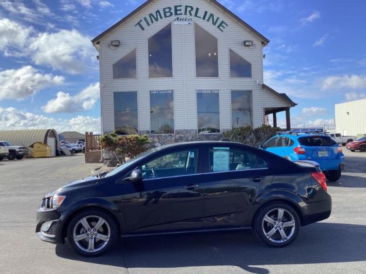 2015 Black Granite Metallic /Jet Black Chevrolet Sonic RS Auto Sedan (1G1JG5SBXF4) with an 1.4L L4 DOHC 24V TURBO engine, 6-Speed Automatic transmission, located at 1235 N Woodruff Ave., Idaho Falls, 83401, (208) 523-1053, 43.507172, -112.000488 - The 2015 Chevrolet Sonic RS is a sporty version of the Chevrolet Sonic, a subcompact car. Here are some of the features you might find on the 2015 Chevrolet Sonic RS: Turbocharged Engine: The Sonic RS is typically equipped with a turbocharged 1.4-liter inline-four engine, which delivers more power - Photo#1