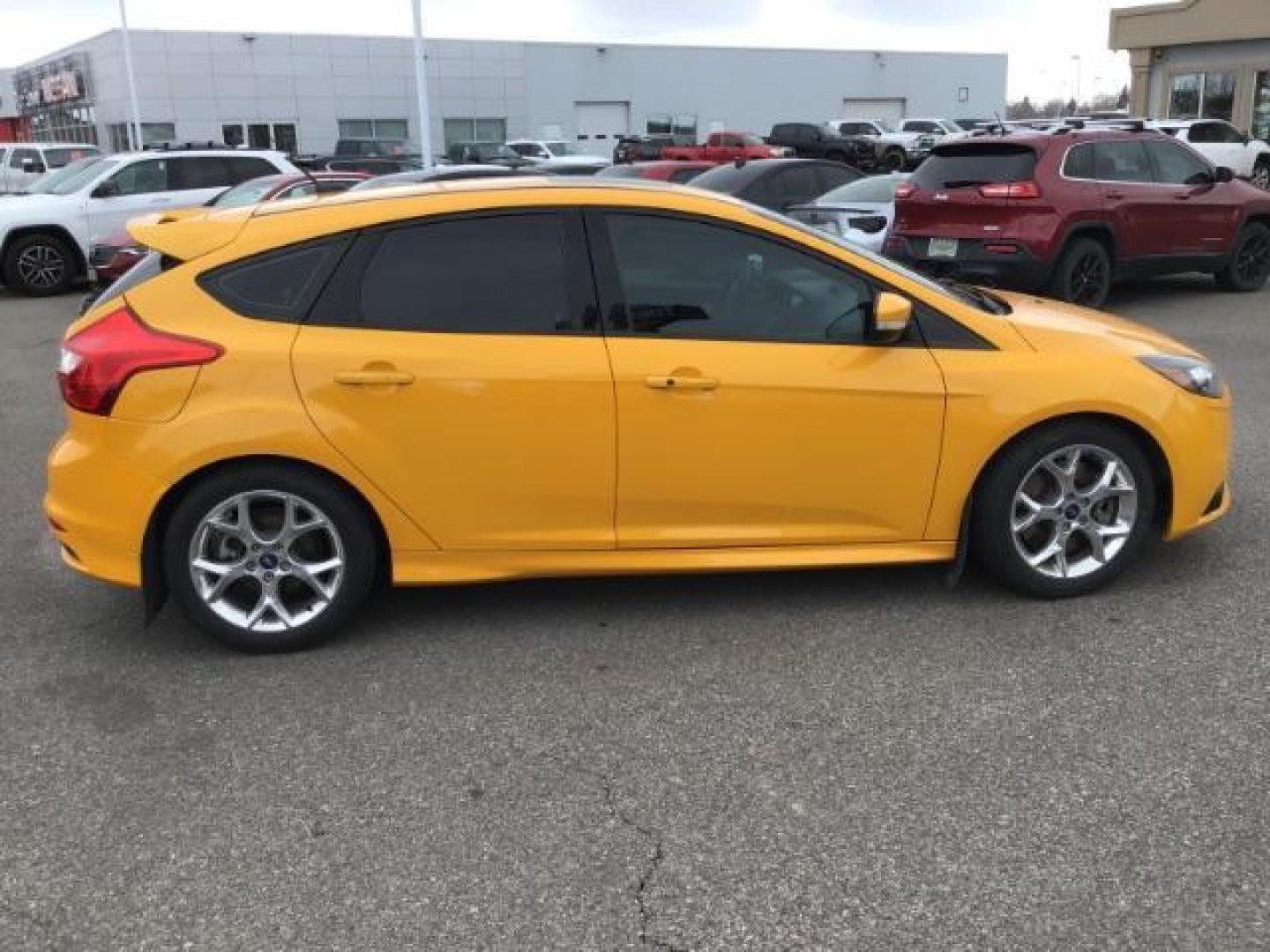 2014 YELLOW /Charcoal Black Ford Focus ST Hatch (1FADP3L96EL) with an 2.0L L4 DOHC 16V engine, 5-Speed Manual transmission, located at 1235 N Woodruff Ave., Idaho Falls, 83401, (208) 523-1053, 43.507172, -112.000488 - This 2014 Ford Focus ST, has 82,000 miles. It has a manual transmission. Comes with Leather interior, heated seats, sunroof, blue tooth audio, touch screen stereo, cruise control, power windows and locks. At Timberline Auto it is always easy to find a great deal on your next vehicle! Our experience - Photo#5