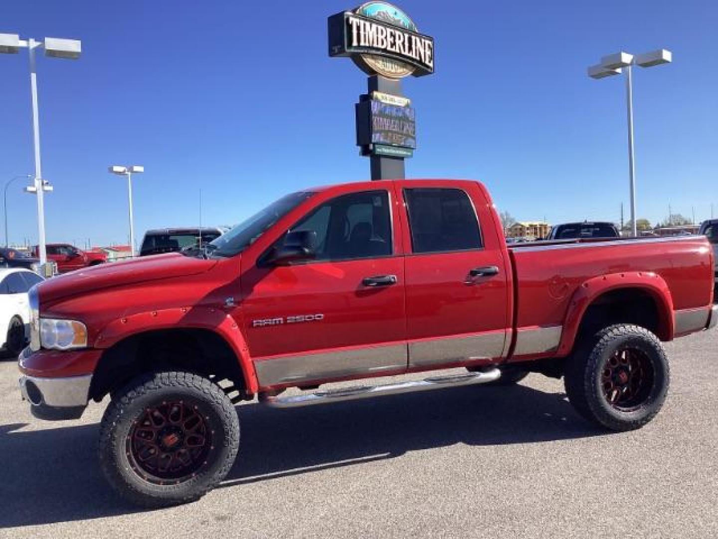 2004 Flame Red /Dark Slate Gray Leather Interior Dodge Ram 2500 SLT Quad Cab 4WD (3D7KU28CX4G) with an 5.9L L6 OHV 24V TURBO DIESEL engine, 5-Speed Automatic transmission, located at 1235 N Woodruff Ave., Idaho Falls, 83401, (208) 523-1053, 43.507172, -112.000488 - The 2004 Dodge Ram 2500 Quad Cab SLT Diesel is a robust and capable truck known for its towing capacity and durability. Here are some of the key features you might find on this model: Engine: Equipped with a powerful and torquey Cummins 5.9-liter inline-six turbocharged diesel engine, known for its - Photo#1