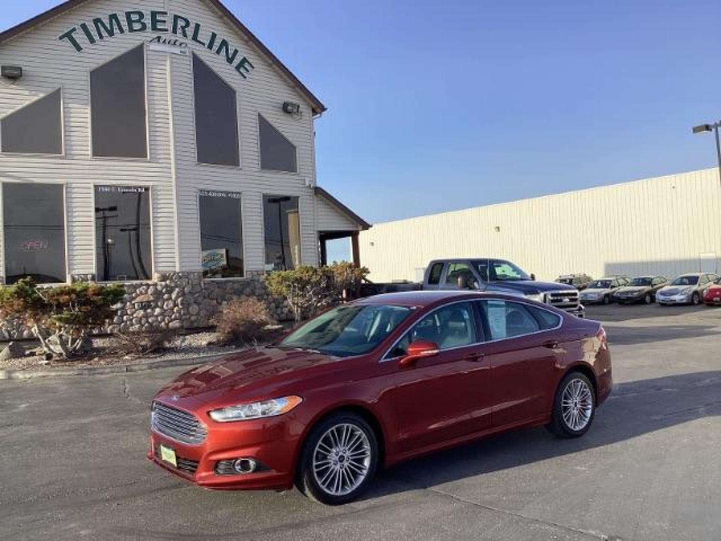 2014 Sunset /Charcoal Black Ford Fusion SE (3FA6P0H95ER) with an 2.0L L4 DOHC 16V engine, 5-Speed Automatic transmission, located at 1235 N Woodruff Ave., Idaho Falls, 83401, (208) 523-1053, 43.507172, -112.000488 - Design: The Fusion features a sleek exterior design that sets it apart from other midsize sedans in its class. With its modern styling, it offers a sophisticated appearance. Performance: The SE trim typically comes with a range of engine options, including fuel-efficient four-cylinder engines and m - Photo#0