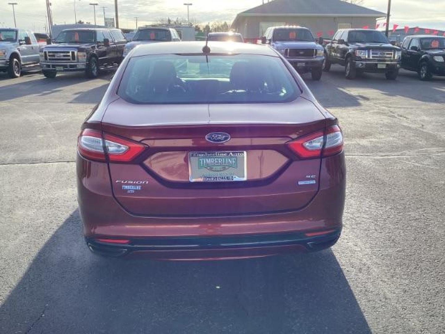 2014 Sunset /Charcoal Black Ford Fusion SE (3FA6P0H95ER) with an 2.0L L4 DOHC 16V engine, 5-Speed Automatic transmission, located at 1235 N Woodruff Ave., Idaho Falls, 83401, (208) 523-1053, 43.507172, -112.000488 - Design: The Fusion features a sleek exterior design that sets it apart from other midsize sedans in its class. With its modern styling, it offers a sophisticated appearance. Performance: The SE trim typically comes with a range of engine options, including fuel-efficient four-cylinder engines and m - Photo#3