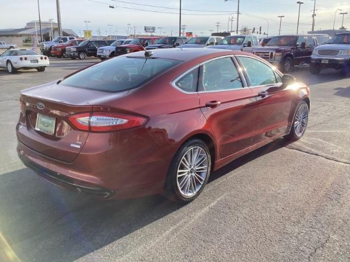 2014 Sunset /Charcoal Black Ford Fusion SE (3FA6P0H95ER) with an 2.0L L4 DOHC 16V engine, 5-Speed Automatic transmission, located at 1235 N Woodruff Ave., Idaho Falls, 83401, (208) 523-1053, 43.507172, -112.000488 - Design: The Fusion features a sleek exterior design that sets it apart from other midsize sedans in its class. With its modern styling, it offers a sophisticated appearance. Performance: The SE trim typically comes with a range of engine options, including fuel-efficient four-cylinder engines and m - Photo#4