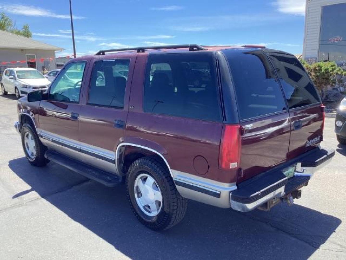 1999 Victory Red Chevrolet Tahoe 4-Door 4WD (1GNEK13R6XJ) with an 5.7L V8 OHV 16V engine, 4-Speed Automatic transmission, located at 1235 N Woodruff Ave., Idaho Falls, 83401, (208) 523-1053, 43.507172, -112.000488 - Photo#2