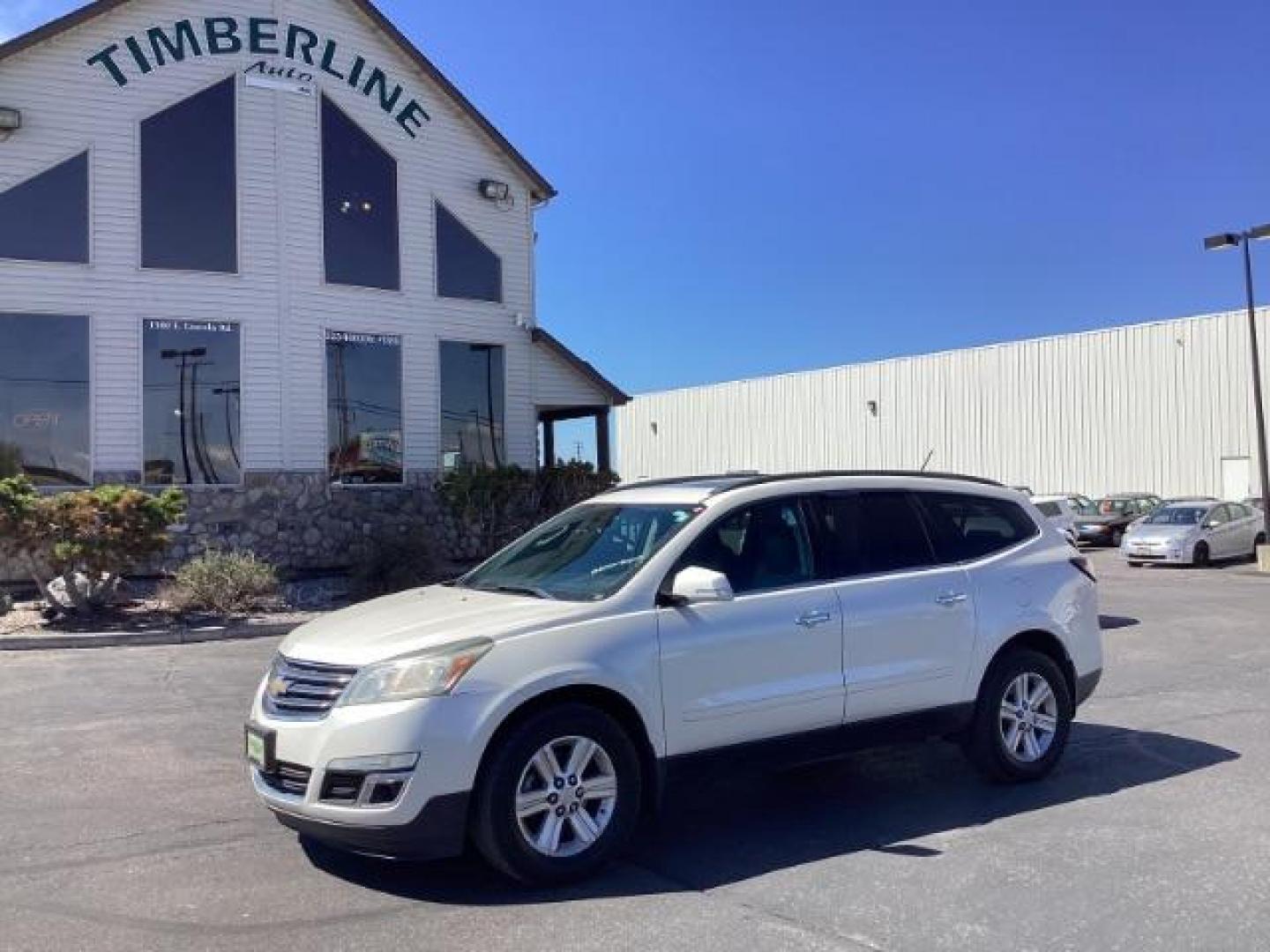 2014 White Diamond Tricoat /Ebony Chevrolet Traverse 2LT AWD (1GNKVHKD1EJ) with an 3.6L V6 DOHC 24V engine, 6-Speed Automatic transmission, located at 1235 N Woodruff Ave., Idaho Falls, 83401, (208) 523-1053, 43.507172, -112.000488 - The 2014 Chevrolet Traverse 2LT AWD is a midsize SUV known for its spacious interior, comfortable ride, and ample cargo space. Here are some of its key features: Engine: It typically comes with a 3.6-liter V6 engine that produces around 281 horsepower, paired with a 6-speed automatic transmission. - Photo#0