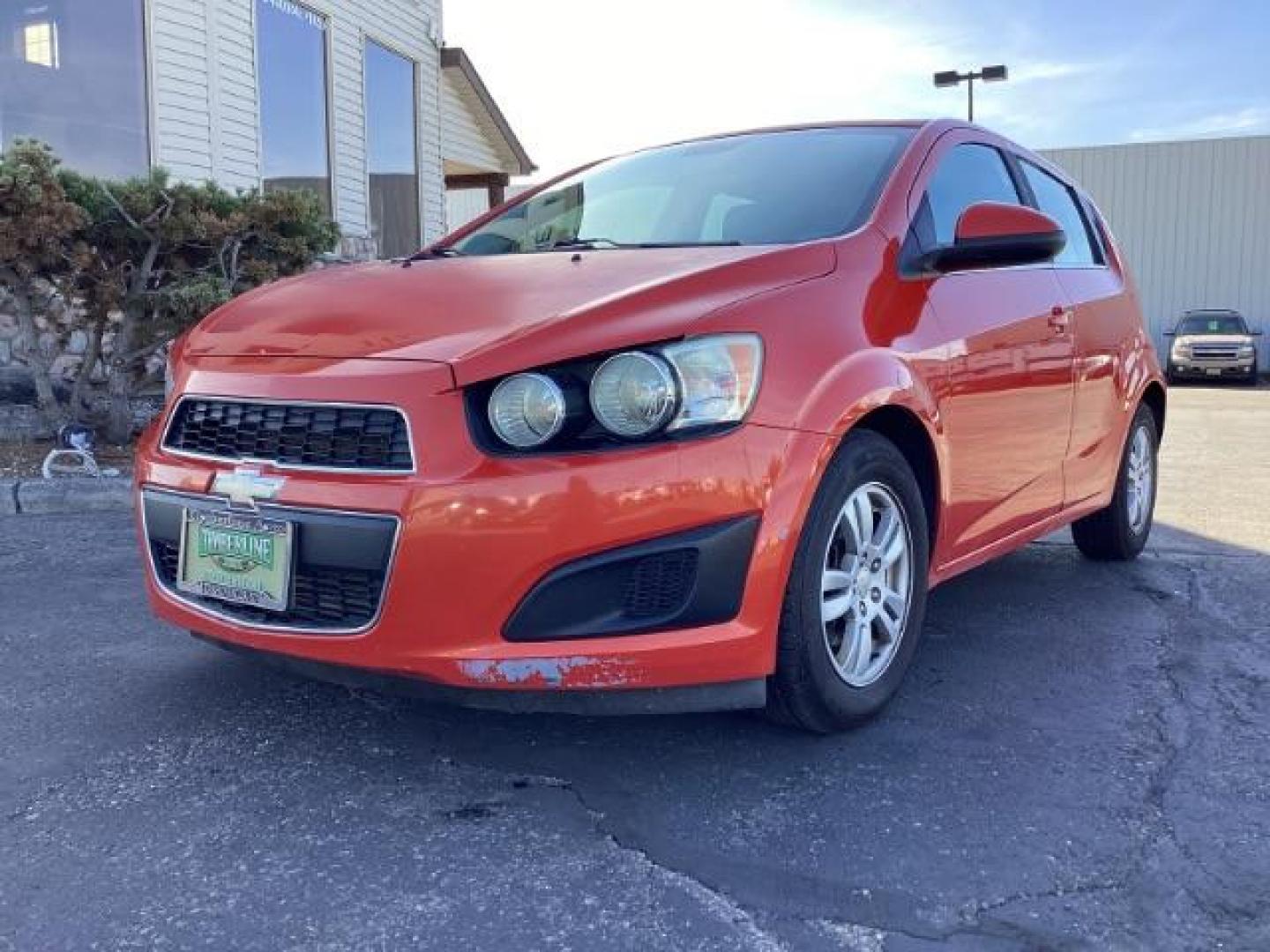 2012 Inferno Orange Metallic /Jet Blk/ Dark Titanium Cloth Interior Chevrolet Sonic 1LT 5-Door (1G1JD6SB5C4) with an 1.4L L4 DOHC 24V TURBO engine, 5-Speed Manual transmission, located at 1235 N Woodruff Ave., Idaho Falls, 83401, (208) 523-1053, 43.507172, -112.000488 - Photo#1