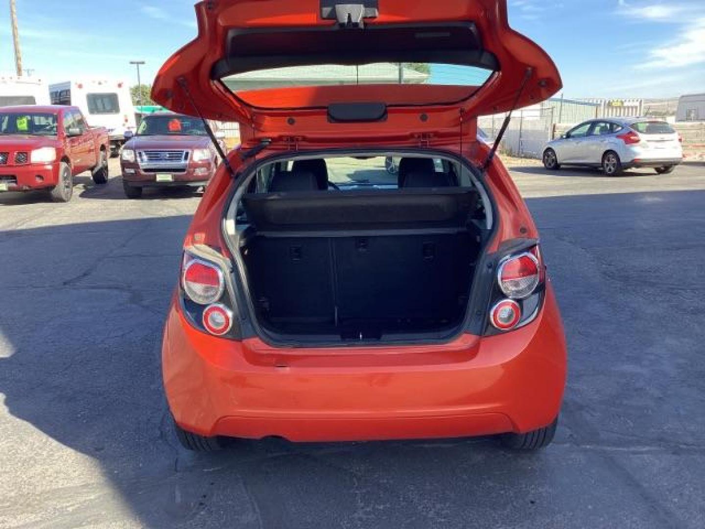 2012 Inferno Orange Metallic /Jet Blk/ Dark Titanium Cloth Interior Chevrolet Sonic 1LT 5-Door (1G1JD6SB5C4) with an 1.4L L4 DOHC 24V TURBO engine, 5-Speed Manual transmission, located at 1235 N Woodruff Ave., Idaho Falls, 83401, (208) 523-1053, 43.507172, -112.000488 - Photo#24