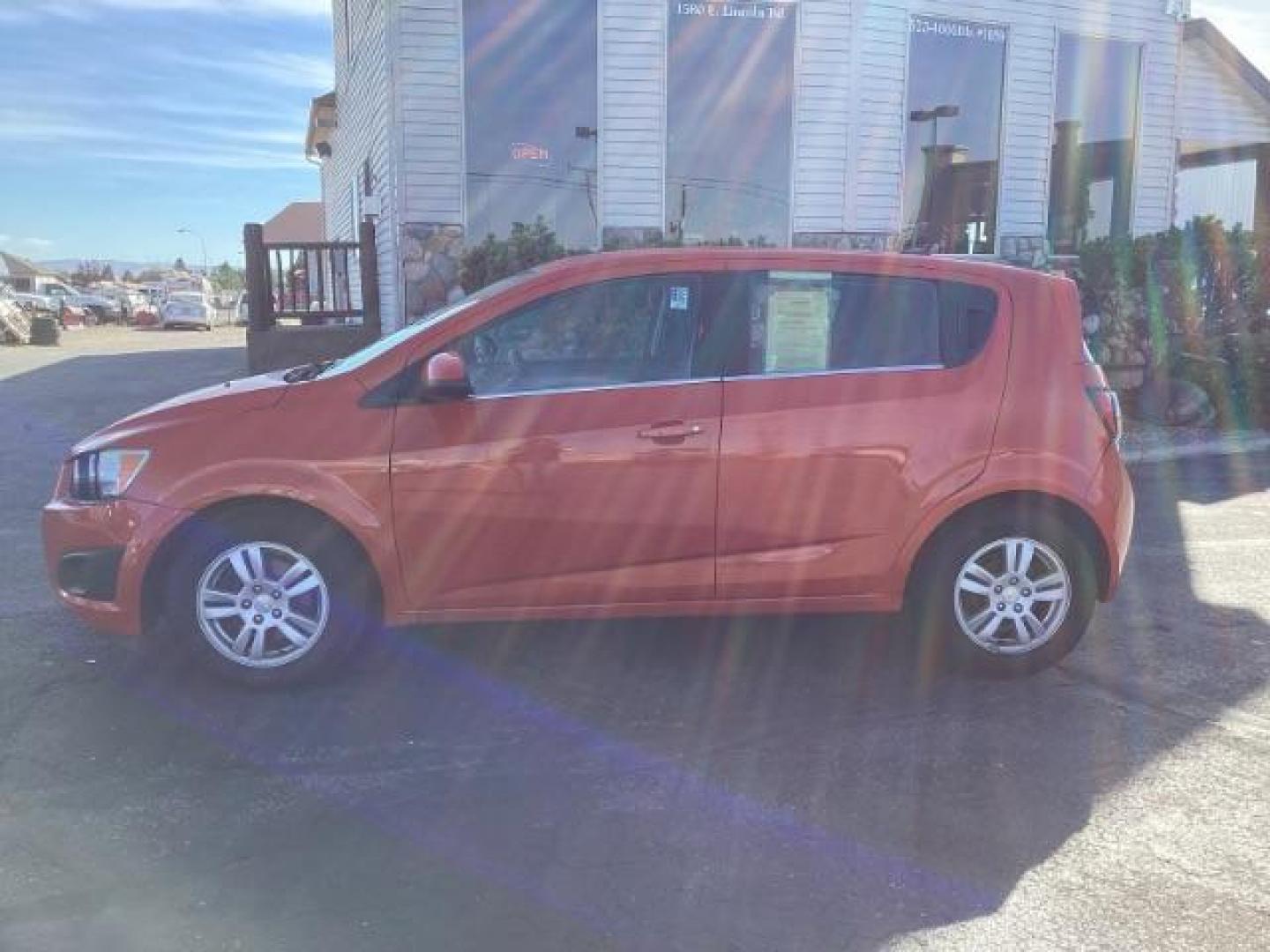 2012 Inferno Orange Metallic /Jet Blk/ Dark Titanium Cloth Interior Chevrolet Sonic 1LT 5-Door (1G1JD6SB5C4) with an 1.4L L4 DOHC 24V TURBO engine, 5-Speed Manual transmission, located at 1235 N Woodruff Ave., Idaho Falls, 83401, (208) 523-1053, 43.507172, -112.000488 - Photo#2