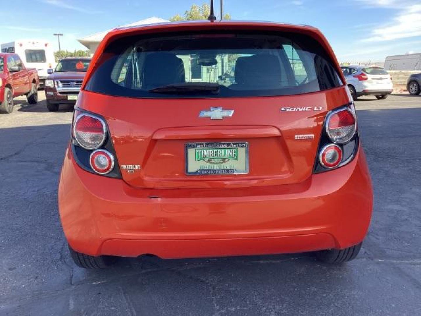 2012 Inferno Orange Metallic /Jet Blk/ Dark Titanium Cloth Interior Chevrolet Sonic 1LT 5-Door (1G1JD6SB5C4) with an 1.4L L4 DOHC 24V TURBO engine, 5-Speed Manual transmission, located at 1235 N Woodruff Ave., Idaho Falls, 83401, (208) 523-1053, 43.507172, -112.000488 - Photo#4