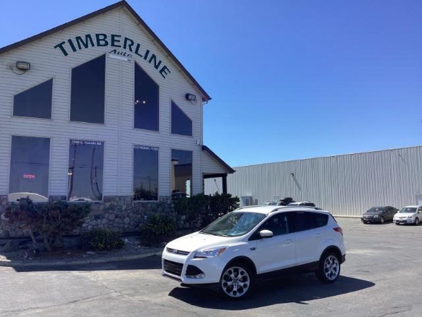 2014 Ingot Silver Metallic Ford Escape Titanium FWD (1FMCU0J95EU) with an 2.0L L4 DOHC 16V engine, 6-Speed Automatic transmission, located at 1235 N Woodruff Ave., Idaho Falls, 83401, (208) 523-1053, 43.507172, -112.000488 - Photo#0