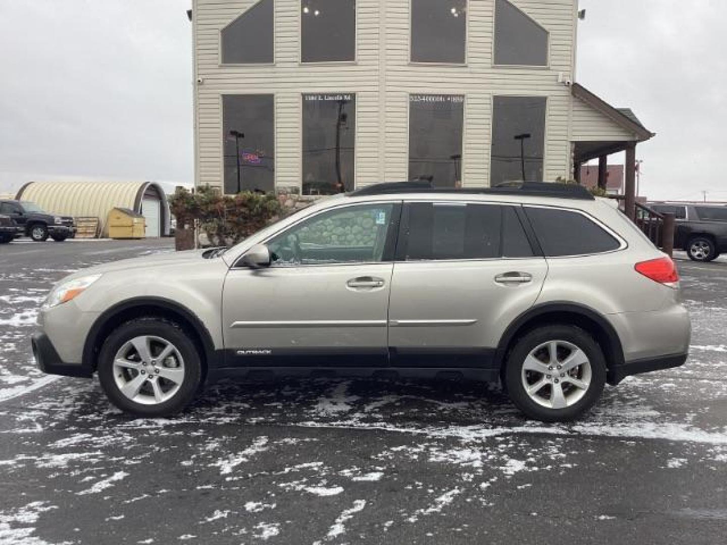 2014 GOLD Subaru Outback 2.5I Premium (4S4BRBDC2E3) with an 2.5L H4 DOHC 16V engine, located at 1235 N Woodruff Ave., Idaho Falls, 83401, (208) 523-1053, 43.507172, -112.000488 - Photo#1