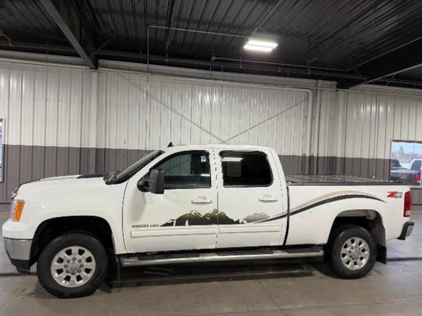 2012 Summit White /Ebony Leather Interior GMC Sierra 2500HD SLT Crew Cab 4WD (1GT121E8XCF) with an 6.6L V8 OHV 32V TURBO DIESEL engine, 6-Speed Automatic transmission, located at 1235 N Woodruff Ave., Idaho Falls, 83401, (208) 523-1053, 43.507172, -112.000488 - Photo#1