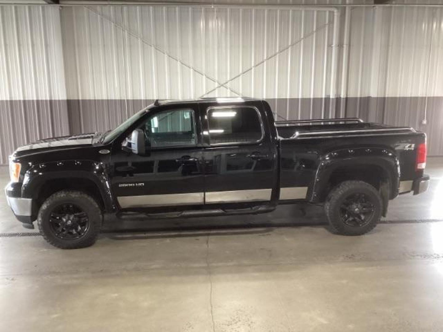 2013 Onyx Black /Ebony Leather Interior GMC Sierra 2500HD SLT Crew Cab 4WD (1GT121E86DF) with an 6.6L V8 OHV 32V TURBO DIESEL engine, 6-Speed Automatic transmission, located at 1235 N Woodruff Ave., Idaho Falls, 83401, (208) 523-1053, 43.507172, -112.000488 - Photo#1